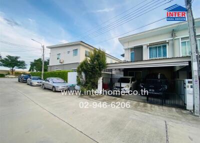 Exterior view of a house with a carport and parked cars