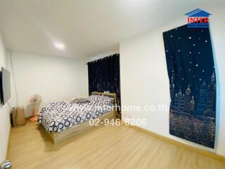 Bedroom with wooden floor, bed, and curtains