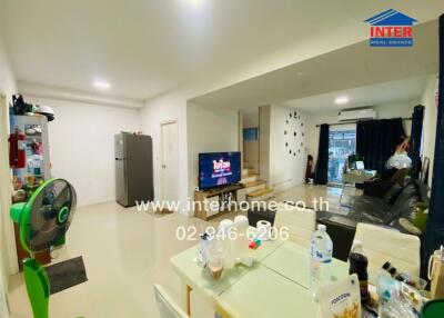 Spacious living area with dining space, furniture, and modern amenities