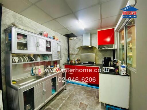 Modern kitchen with stainless steel cabinets and black countertops