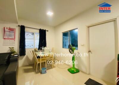 Bright dining room with table, chairs, and windows