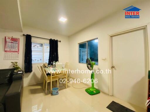 Bright dining room with table, chairs, and windows