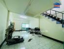 Living area with tiled flooring and staircase