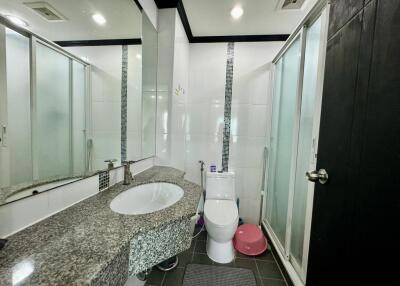 Modern bathroom with glass shower and granite countertop