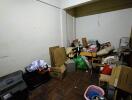 cluttered storage room with boxes and miscellaneous items