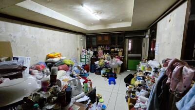 Cluttered living space with boxes and various items