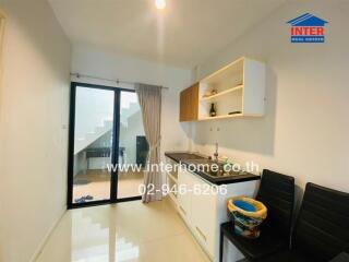 Modern kitchen area with adjacent seating and sliding glass door