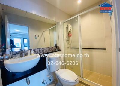 Modern bathroom with sink, toilet, and enclosed shower