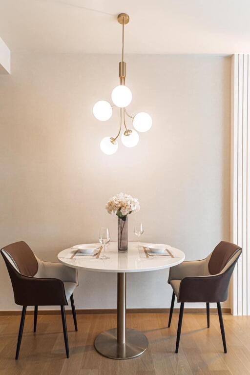 Modern dining area with a round table and plush chairs