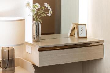 Bedroom vanity with lamp and flowers