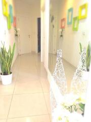 Bright hallway with decorative plants and colorful wall frames