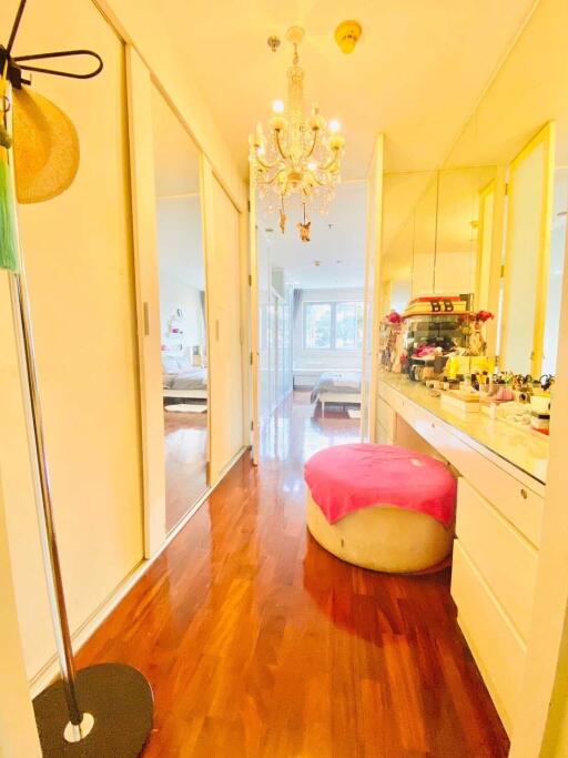 bright bedroom with chandelier and makeup vanity