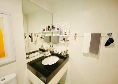 Modern bathroom with black countertop and large mirror