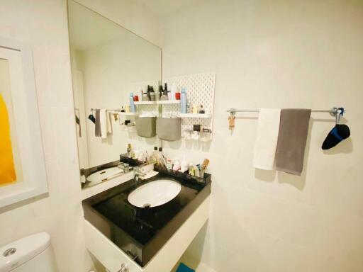 Modern bathroom with black countertop and large mirror