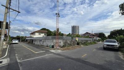 View of a neighborhood with houses, roads, and a transmission tower