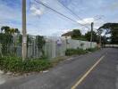 Photo of a fenced plot of land next to a road