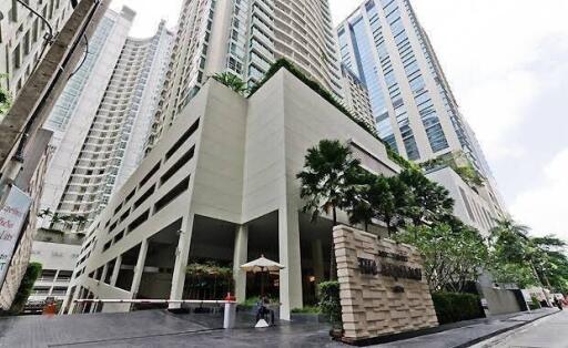 Large modern high-rise building exterior with multiple floors and balconies