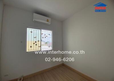 Minimalist bedroom with air conditioning unit and window