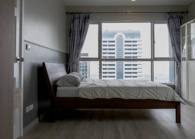 Modern bedroom with large window and city view