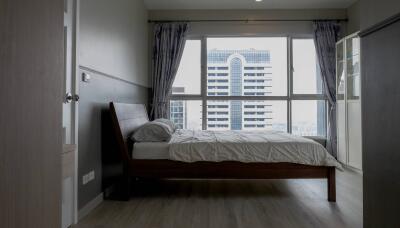 Modern bedroom with large window and city view