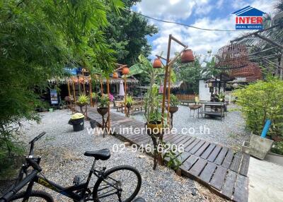 Outdoor seating area with a garden and a bicycle