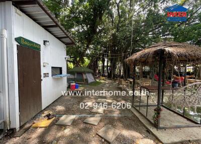 Outdoor area with building, tents, and gazebo