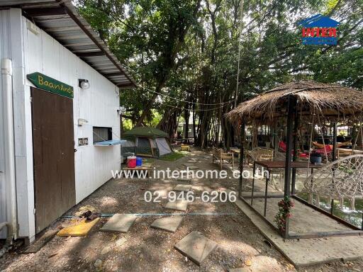 Outdoor area with building, tents, and gazebo