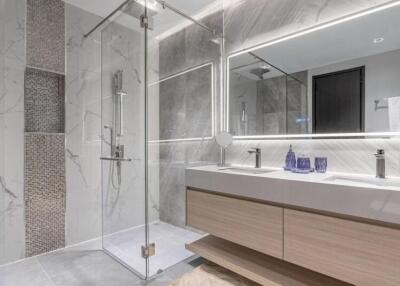 Modern bathroom with glass shower, double sink vanity, and large mirror