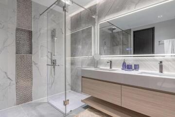 Modern bathroom with glass shower, double sink vanity, and large mirror