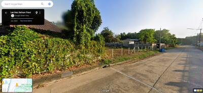 Exterior view of property with lush greenery and a road