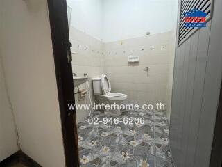 Bathroom with tiled floor and white fixtures