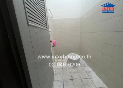 Small, tiled bathroom with minimal features