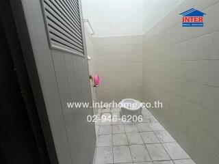 Small, tiled bathroom with minimal features