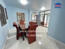 Spacious dining room with a glass-top table and wicker chairs, bright lighting, and tiled flooring