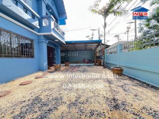 Exterior view of a blue house with a driveway