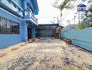 Exterior view of a blue house with a driveway