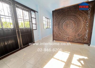 sunroom with decorative wooden partition and large windows