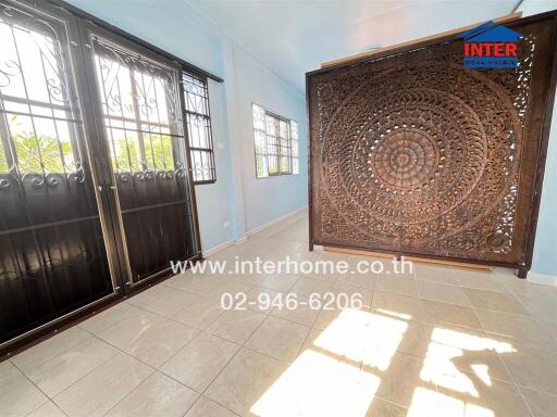 sunroom with decorative wooden partition and large windows