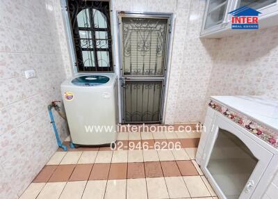 Utility room with washing machine and storage space