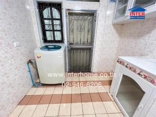 Utility room with washing machine and storage space