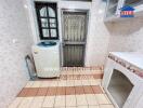 Utility room with washing machine and storage space