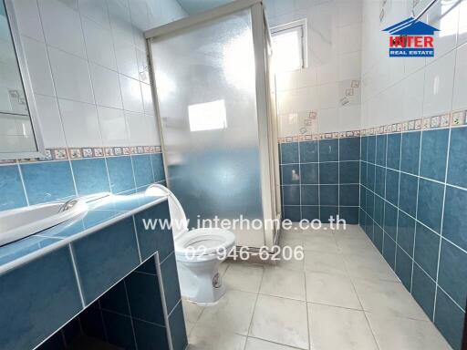 Bathroom with blue tiles and shower area