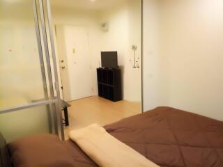 Bedroom with a TV and shelving unit