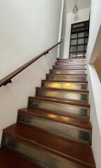 A staircase with wooden steps and glass risers.