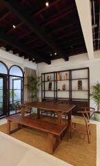 Elegant dining area with wooden table, benches, indoor plants, and decorative shelves