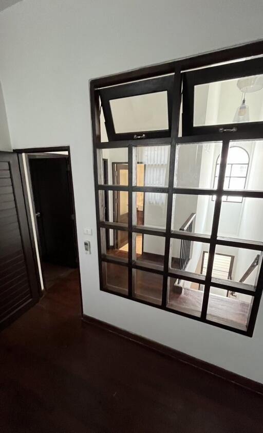 View of a hallway with a window looking into a staircase area