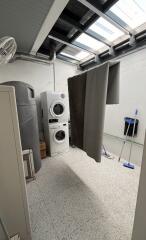 laundry room with washer and dryer, water heater, and skylight