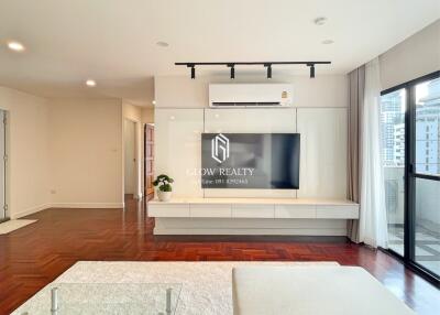 Spacious, modern living room with large flat-screen TV and air conditioning