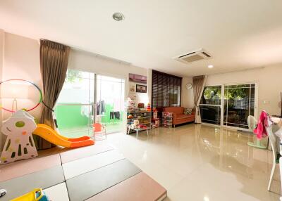 Spacious living room with play area and large windows