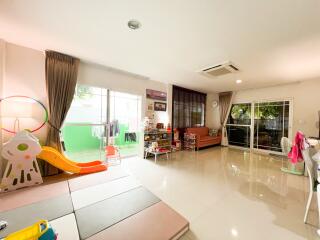 Spacious living room with play area and large windows